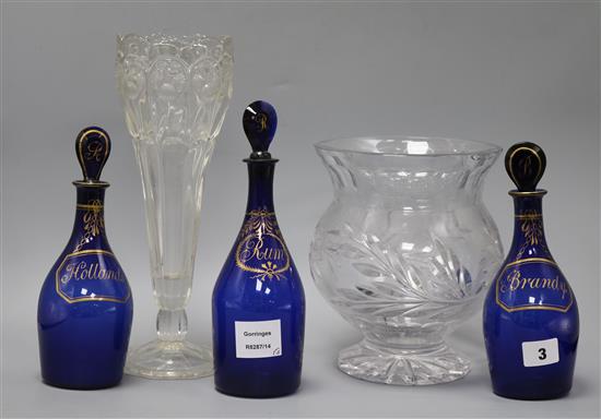 Three Bristol blue glass decanters and stoppers, Brandy, Rum and Hollands, and two vases tallest 25cm